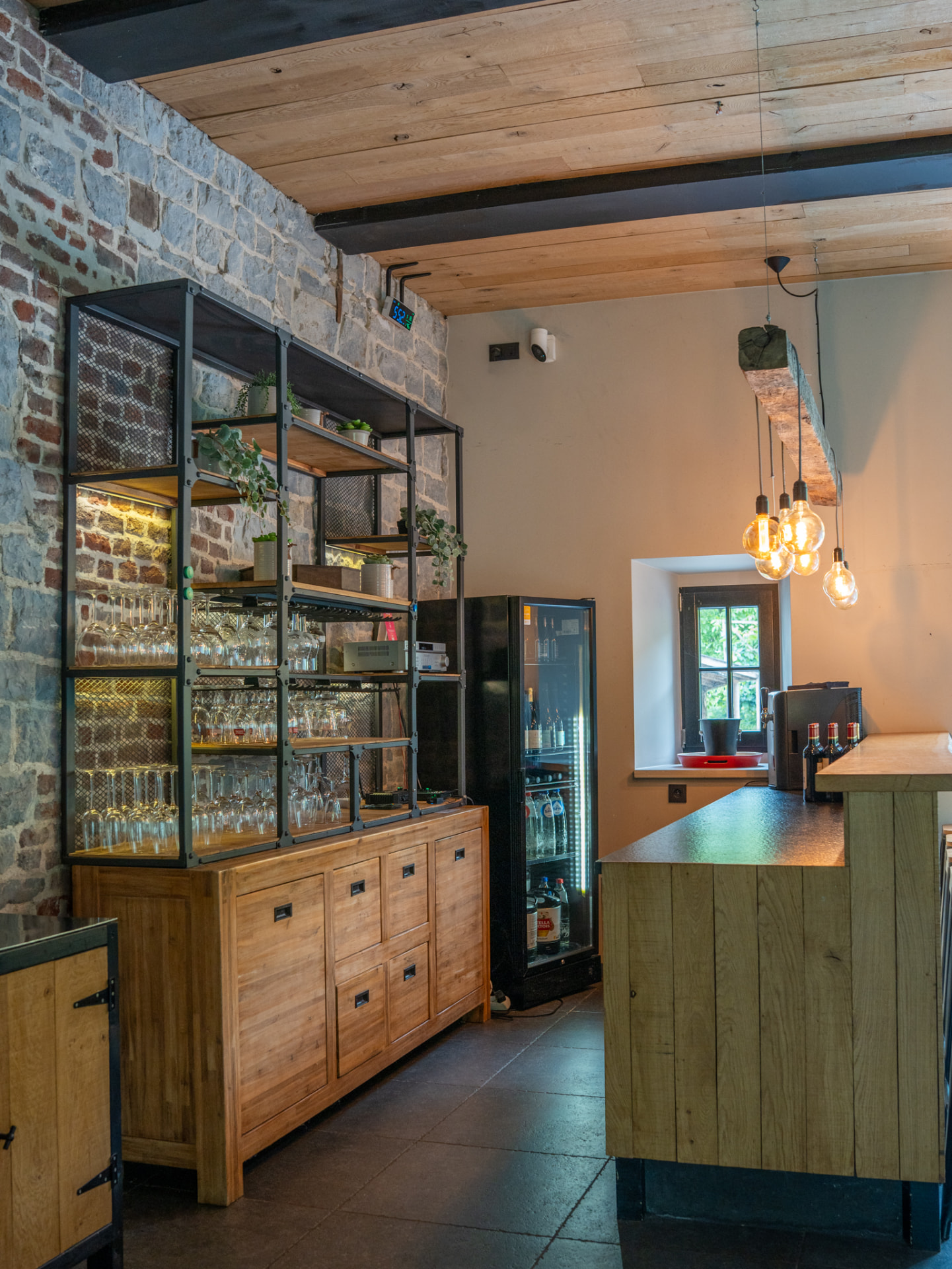 De bar met natuurstenen muur en houten kasten